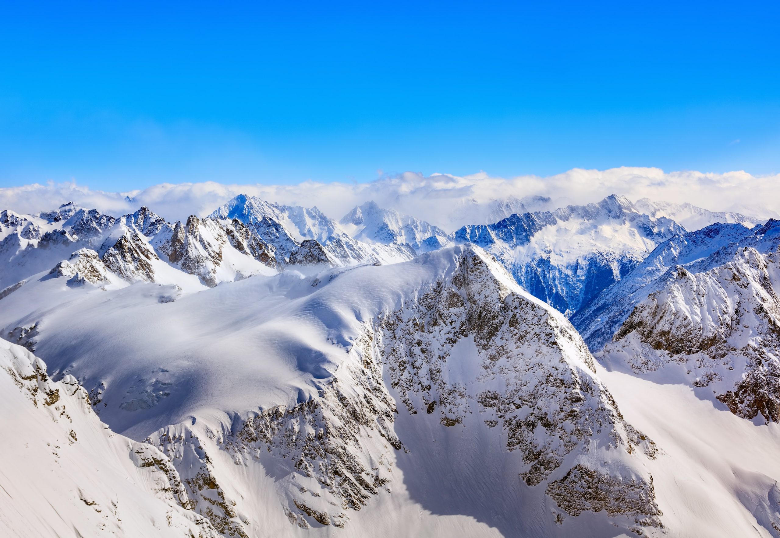 areal-photography-of-snow-coated-mountains-under-clear-blue-753772